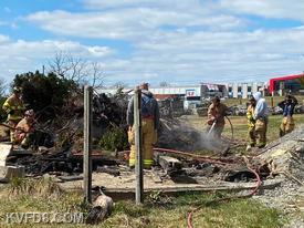 Firefighters extinguishing an unauthorized burn of debris. 